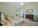 Cozy bedroom featuring a floral bedspread, ceiling fan, and ample natural light at 2598 Ekana Dr, Oviedo, FL 32765