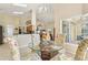 Bright dining area with tile floors, floral dining chairs, and view of the kitchen and living room at 2598 Ekana Dr, Oviedo, FL 32765