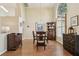 Dining room with hardwood floors, dark wood furnishings, a pendant light, and high arched window at 2598 Ekana Dr, Oviedo, FL 32765