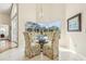Casual dining area with tile floors and bright window with pool view and floral dining chairs at 2598 Ekana Dr, Oviedo, FL 32765