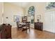 Elegant dining room with hardwood floors, stylish furnishings, and a bright arched window at 2598 Ekana Dr, Oviedo, FL 32765