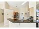 Kitchen island with a view to a laundry room with updated appliances and granite countertops at 2598 Ekana Dr, Oviedo, FL 32765