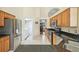Kitchen with stainless steel appliances, granite countertops, and adjacent laundry area at 2598 Ekana Dr, Oviedo, FL 32765