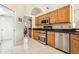 Well-lit kitchen with stainless steel appliances, granite countertops, and ceramic tile floors at 2598 Ekana Dr, Oviedo, FL 32765