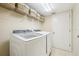 A well-lit laundry room features modern appliances and plenty of shelf space for storage and organization at 2598 Ekana Dr, Oviedo, FL 32765