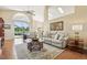 Bright living room boasts a vaulted ceiling, fan, patio access, and comfortable seating at 2598 Ekana Dr, Oviedo, FL 32765