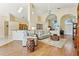 Open-concept living room featuring vaulted ceilings, arched doorways, hardwood floors, and neutral decor at 2598 Ekana Dr, Oviedo, FL 32765
