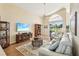 Spacious living room features vaulted ceilings, fan, stylish furniture, and patio views at 2598 Ekana Dr, Oviedo, FL 32765