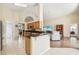 Open living room and kitchen area, featuring lots of light, an island, and vaulted ceilings at 2598 Ekana Dr, Oviedo, FL 32765