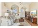 Inviting living room with neutral walls, hardwood floors, and arched doorways for an open feel at 2598 Ekana Dr, Oviedo, FL 32765