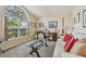 Comfortable living room with a large window, neutral carpet, and a stylish glass coffee table at 2598 Ekana Dr, Oviedo, FL 32765