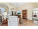 Open living room with hardwood floors, bookshelves, and neutral colors flows into other rooms at 2598 Ekana Dr, Oviedo, FL 32765