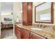 Well lit main bathroom with and sinks and a view of the bedroom in the background at 2598 Ekana Dr, Oviedo, FL 32765