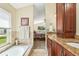 Well lit main bathroom with and sinks and a large bathtub, bedroom in background at 2598 Ekana Dr, Oviedo, FL 32765