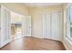 Office featuring wood floors, a closet, a window, and an open doorway to the screened-in patio at 2598 Ekana Dr, Oviedo, FL 32765