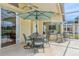 Covered patio features outdoor seating, a ceiling fan, and serene views of the pool area at 2598 Ekana Dr, Oviedo, FL 32765
