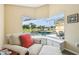 Sitting area with chair, ottoman, built-in storage, and a view of the screened-in pool area at 2598 Ekana Dr, Oviedo, FL 32765