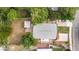 Aerial view showcasing the house, patio, landscaping, driveway and shed surrounded by mature trees at 2825 Mayer St, Orlando, FL 32806