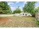 Spacious backyard with green grass, a storage shed, and mature trees, offering privacy and shade at 2825 Mayer St, Orlando, FL 32806