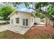 Charming cottage-style home with a well-maintained backyard, featuring a patio and lush landscaping at 2825 Mayer St, Orlando, FL 32806