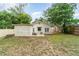 Expansive backyard with a shed, lush greenery, and mature trees, providing ample outdoor space at 2825 Mayer St, Orlando, FL 32806