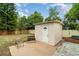 Backyard shed surrounded by lush greenery, providing extra storage or workspace at 2825 Mayer St, Orlando, FL 32806