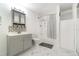 Modern bathroom with marble floors, updated vanity, tub with shower, and stylish gray accents at 2825 Mayer St, Orlando, FL 32806