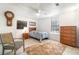 Well-lit bedroom featuring a ceiling fan, large windows, and neutral decor at 2825 Mayer St, Orlando, FL 32806