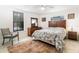 Bright bedroom with a wooden bed frame, ample natural light, and neutral decor at 2825 Mayer St, Orlando, FL 32806