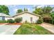Inviting single-story home with a well-maintained front yard and a cozy carport, perfect for outdoor relaxation at 2825 Mayer St, Orlando, FL 32806