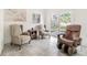 Cozy seating area with three chairs, side table, tile floors, and French doors to bring the outside in at 2825 Mayer St, Orlando, FL 32806