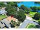 A beautiful aerial view showcases a home's proximity to a picturesque lake and a community park at 2828 Whispering Way, Winter Park, FL 32792