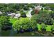 An aerial view that shows a neighborhood, nearby tennis courts, and a pond at 2828 Whispering Way, Winter Park, FL 32792