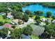 Picturesque community featuring tennis courts, beautiful landscaping, and a stunning lake in a residential area at 2828 Whispering Way, Winter Park, FL 32792