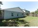 Side view of backyard and home, showing the large, grassy yard and windows at 2828 Whispering Way, Winter Park, FL 32792
