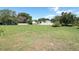 Large grassy back yard in residential community with homes in the distance at 2828 Whispering Way, Winter Park, FL 32792