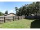 Fenced in back yard with green grass and privacy fence in suburban community at 2828 Whispering Way, Winter Park, FL 32792