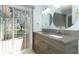 Bathroom featuring double vanities, granite countertop, modern fixtures and a sliding glass door at 2828 Whispering Way, Winter Park, FL 32792