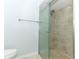Updated walk-in shower with glass doors and modern fixtures with a toilet to the side at 2828 Whispering Way, Winter Park, FL 32792