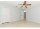 Bright bedroom with tile floors, ceiling fan, white doors, and fresh paint at 2828 Whispering Way, Winter Park, FL 32792