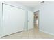 Spacious bedroom featuring tiled floors, closet, and neutral paint at 2828 Whispering Way, Winter Park, FL 32792