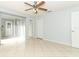 Bedroom with tile flooring, ceiling fan, and access to the exterior and additional rooms at 2828 Whispering Way, Winter Park, FL 32792