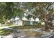 Home with a garage and a well-maintained lawn in a suburban neighborhood at 2828 Whispering Way, Winter Park, FL 32792