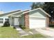 Charming one-story home with a two-car garage and well-maintained lawn at 2828 Whispering Way, Winter Park, FL 32792