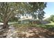 View of home from street showing walkway, lawn and lush, mature trees providing shade at 2828 Whispering Way, Winter Park, FL 32792