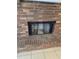 Close-up of a brick fireplace with black mesh cover at 2828 Whispering Way, Winter Park, FL 32792