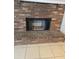 Close-up of a brick fireplace with black mesh cover at 2828 Whispering Way, Winter Park, FL 32792