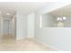 Open hallway with large, light colored tiles and neutral paint, leading to other rooms at 2828 Whispering Way, Winter Park, FL 32792