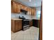 Traditional kitchen featuring brown wood cabinets and stainless steel appliances at 2828 Whispering Way, Winter Park, FL 32792