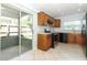 Well-lit kitchen with stainless steel appliances, ample cabinetry, and outdoor access at 2828 Whispering Way, Winter Park, FL 32792